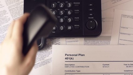 Woman phoning to find out about retirement banking plan 401k.