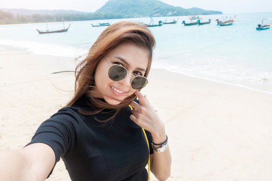  woman tourist is selfie  in Phuket sea in Thailand