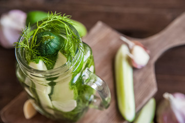 Fermented food in a can. Cucumbers, dill, garlic, marinade. National Russian food pickles in brine close up and copy space