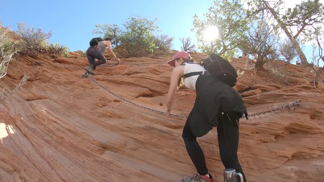 Two girls climbing the Angels Landing hike in Zion National Park, Utah, USA