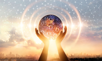 Hands holding earth and wave circle global structure network connection and data exchanges customers worldwide on sunset background. Innovation and inspiration. Networking and technology concept