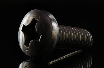 Metal screw close-up with pronounced texture and reflection