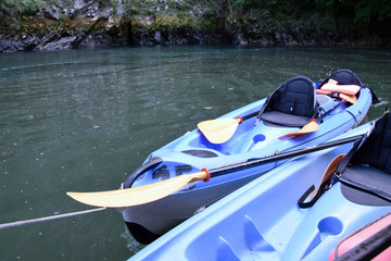 Kayaks on canyon river.