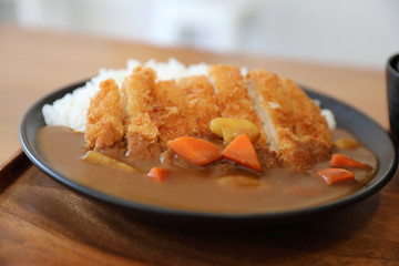 Curry rice with fried pork tonkatsu Japanese food on wooden table