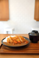 Curry rice with fried pork tonkatsu Japanese food on wooden table
