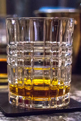 A glass of whiskey, burborne, brandy, rum or brandy. Expensive drink in the bar. Male strong alcohol. Refined taste. Long exposure. Elite distillery. Scotch or Irish whiskey.