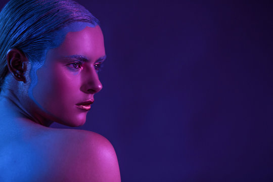 Beautiful stylish model with half face on a purple background.