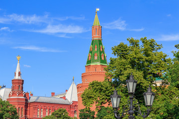 Fototapeta na wymiar Towers of Moscow Kremlin and State Historical Museum against blue sky at sunny day