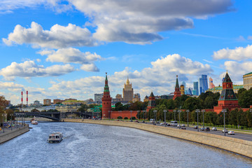 Panorama of Moscow Kremlin in sunny day on a background of Moskva river and blue sky with white clouds