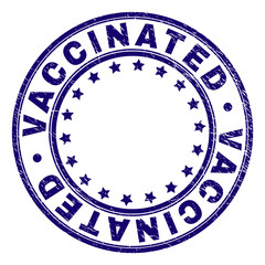 VACCINATED stamp seal imprint with distress texture. Designed with round shapes and stars. Blue vector rubber print of VACCINATED title with scratched texture.