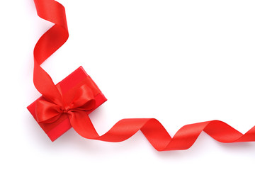 Red gift box with red ribbon on white background. Top view