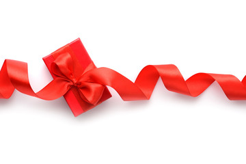 Red gift box with red ribbon on white background. Top view