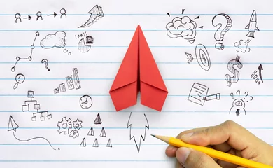 Tuinposter Business success, innovation and solution concept, Red paper plane and business strategy with hand drawing on notebook © Worawut
