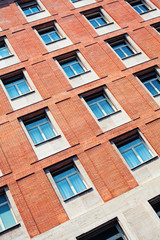 Fototapeta na wymiar Modern architecture background. Red brick wall and window