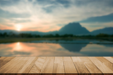 Fototapeta na wymiar wood tabletop with blurred amazing landscape background.