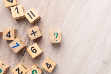 Wooden cubes with numbers. Teaching a child of preschool age mathematics. question mark. child learns numbers
