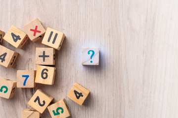 Wooden cubes with numbers. Teaching a child of preschool age mathematics. question mark. child learns numbers