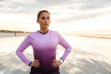 Female runner recovering after beach jog