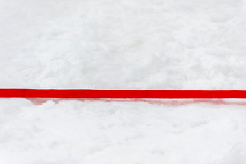 Snow volleyball court up close and in detail with red plastic line marker