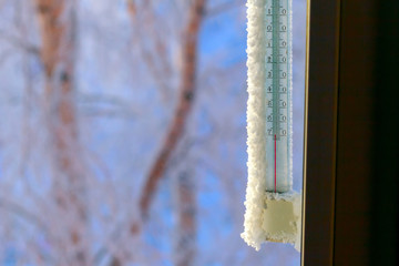 Classic mercury thermometer for measuring ambient temperature, hanging outside the window, with readings minus 50 degrees Celsius.