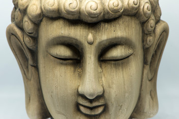 Fototapeta na wymiar The face of a buddha figure meditating