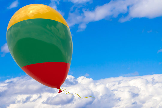 Balloon with the image of the state flag of Lithuania, flying against the blue sky.