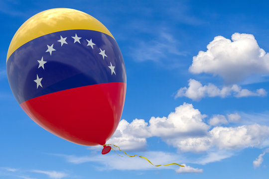 Balloon with the image of the national flag of Venezuela, flying against the blue sky.