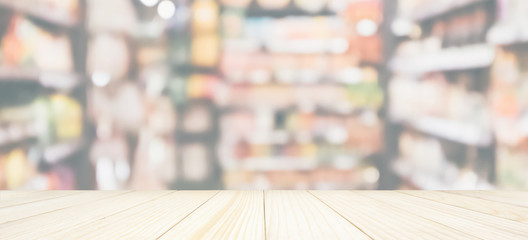 Wood table top with Abstract supermarket grocery store refrigerator blurred defocused background with bokeh light