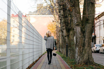 Portrait of a young beautiful blonde girl walking on the streets