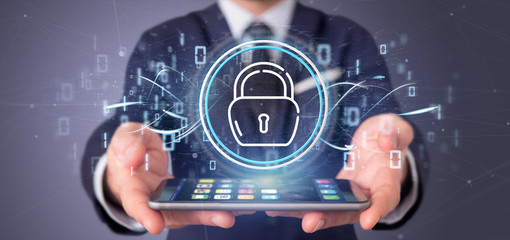 Businessman holding Security padlock wheel icon with stats and binary code 3d rendering