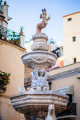 Fototapeta na wymiar TAORMINA, ITALY - OCTOBER 16, 2014: Fountain on Piazza del Duomo in Taormina city in Sicily. Baroque fountain with two centaurs and bust of an angel