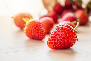 Fresh organic red ripe Strawberry fruit on wood background closeup