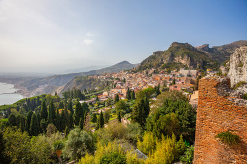 Fototapeta na wymiar Panoramic view from Taormina city to Sicily shore, Etna volcano is hidden in clouds