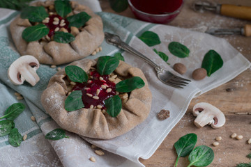 Pies with mushrooms, chicken, spinach and lingonberry sauce.