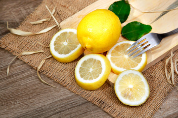 Fototapeta na wymiar slices of fresh lemon on cutting board