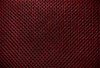 beautiful sport cloth texture pattern background dark red color, close up of dark red textile with pattern of holes, arrange of pattern design on soft hot red synthetic fabric background