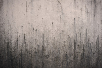 old dirty background with dripping stain on the wall, detail of texture of black trickle on...