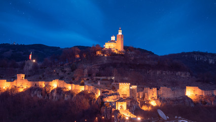 Beautiful panoramic view of illuminated medieval Tsarevets fortress in Veliko Tarnovo, Bulgaria at...