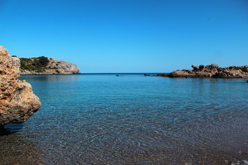 Perfect summer holidays concept, crystal clear sea, sea rocks, blue sky