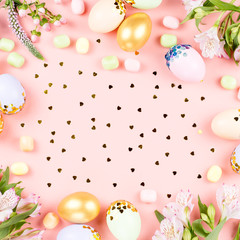Fototapeta na wymiar Festive Happy Easter background with decorated eggs, flowers, candy and ribbons in pastel colors on white. Copy space