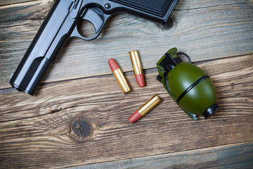 hand gun, grenade and cartridges