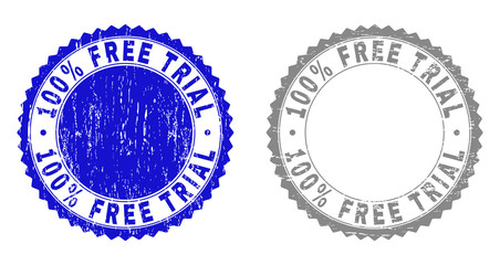100% FREE TRIAL stamp seals with grunge texture in blue and grey colors isolated on white background. Vector rubber overlay of 100% FREE TRIAL title inside round rosette.