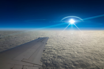 UFO flies near airplane in dark blue sky