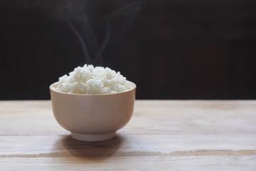 White steamed rice in brown bowl.