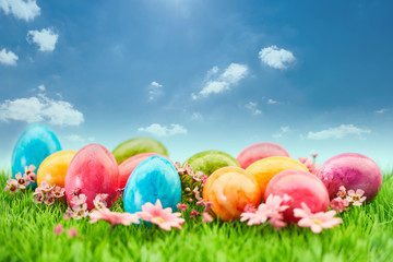 Viele bunte Ostereier zu Ostern auf Wiese