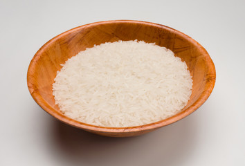 Rice in a brown bowl on white background