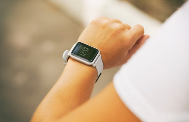 Woman is looking on her smart watches on her hand