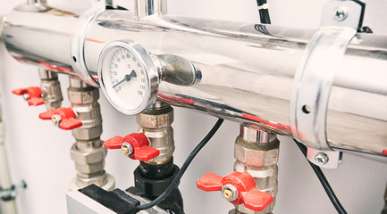 A lot of different faucets and other equipment for boiling room