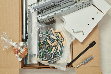 The furniture assembler joins together the two parts of the ready-to-assemble furniture with cam...