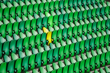 Seating rows in a stadium with weathered chairs